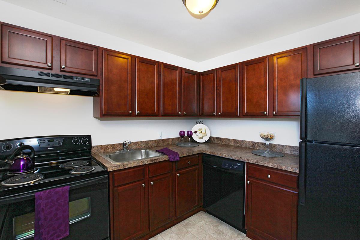 a kitchen with stainless steel appliances and wooden cabinets