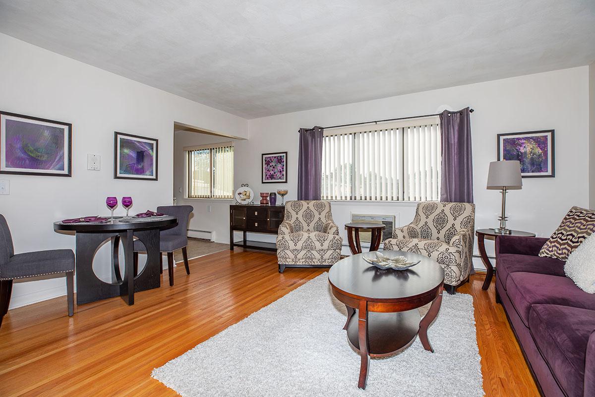 a living room filled with furniture and a flat screen tv