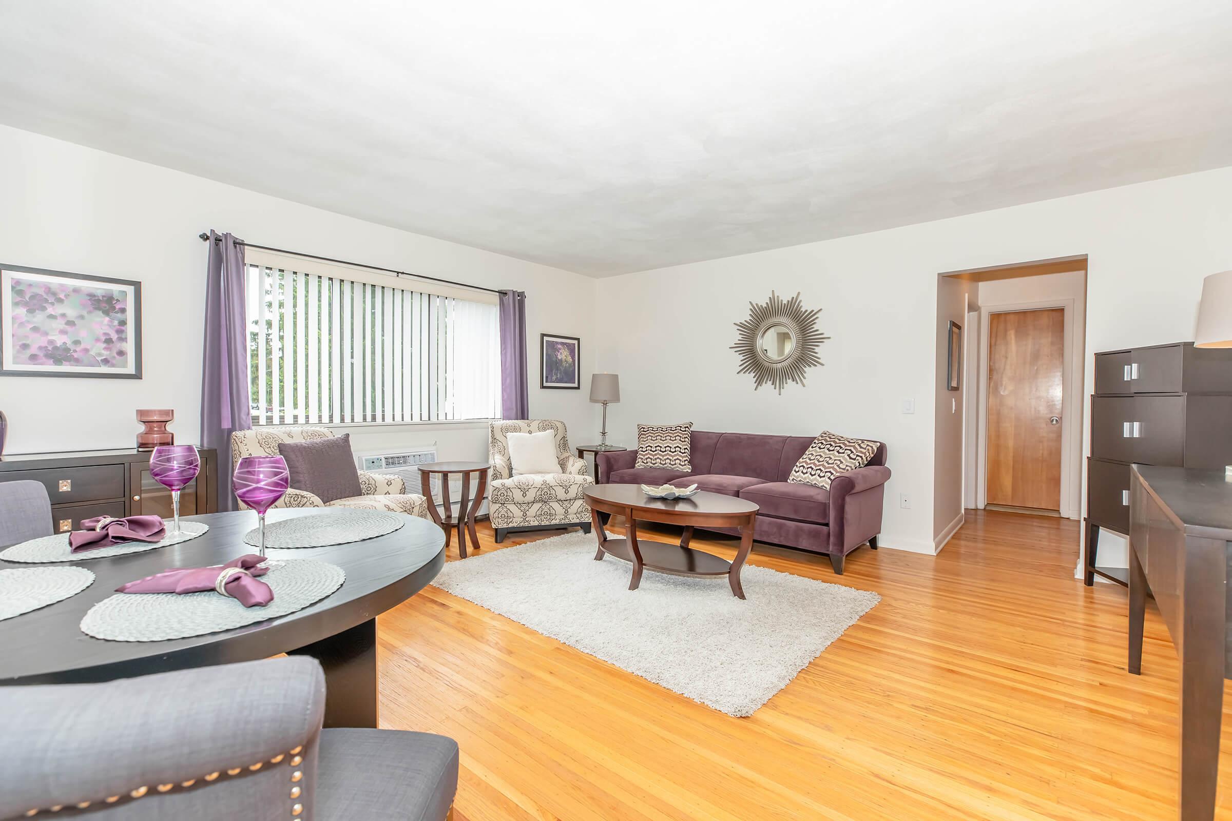 a living room filled with furniture and a flat screen tv