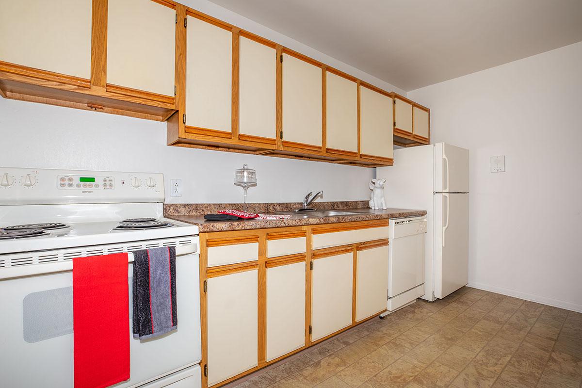 a stove top oven sitting inside of a kitchen