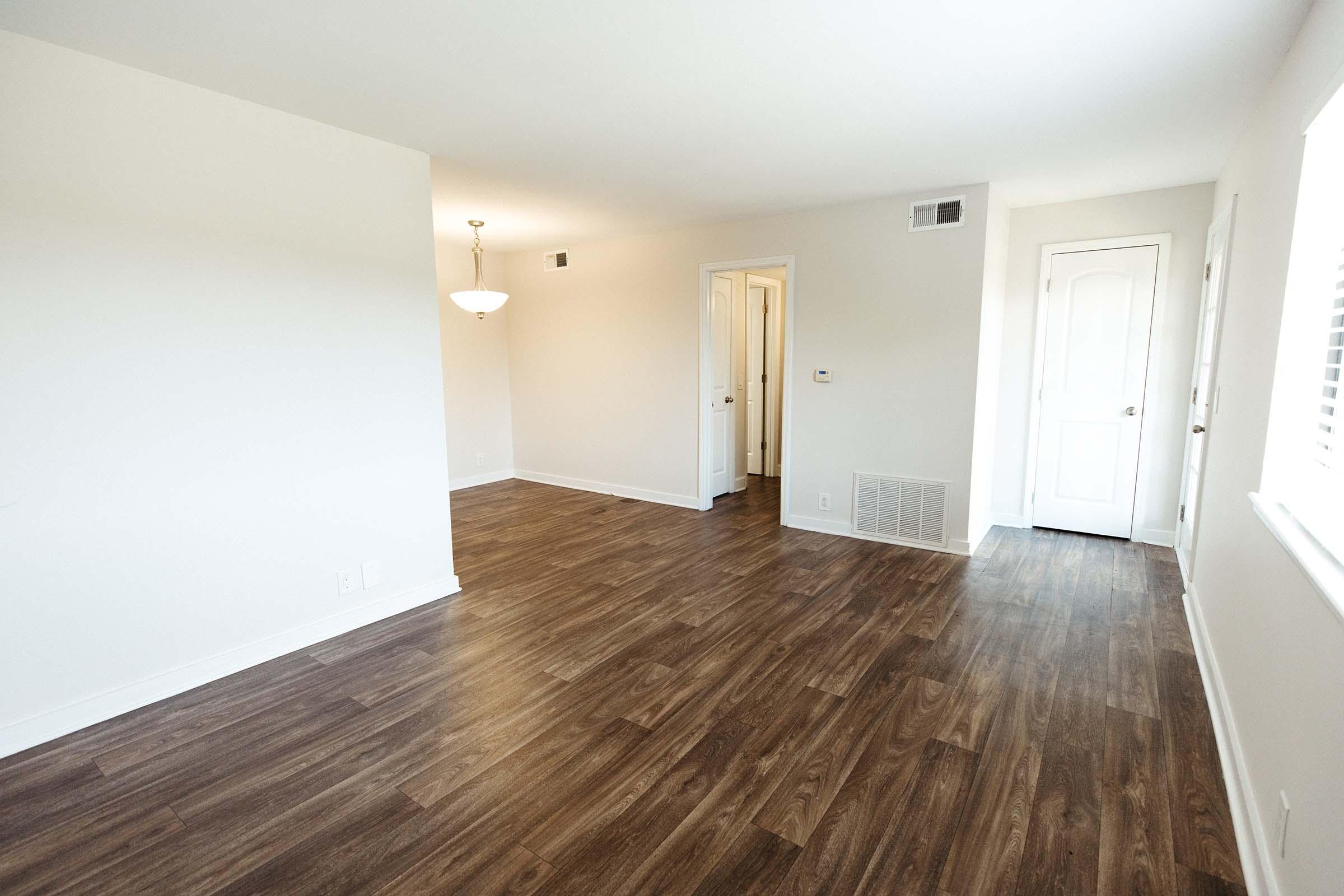 a large empty room with a wooden floor