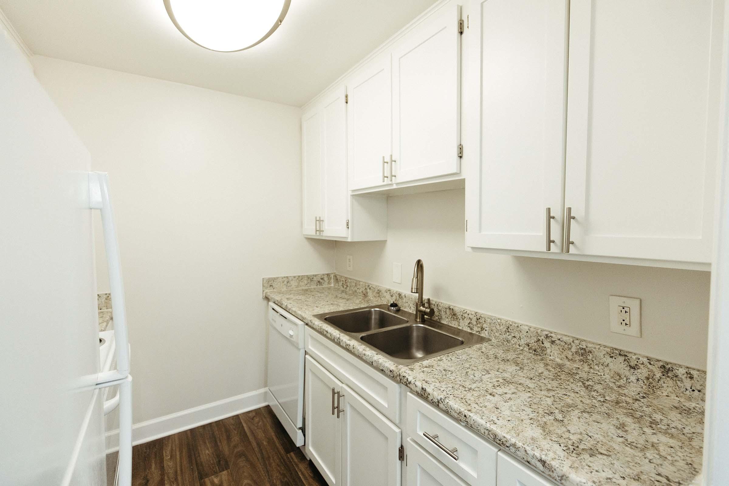 a kitchen with a sink and a mirror