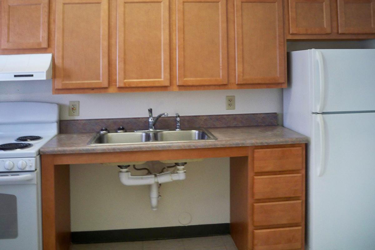 a kitchen with a stove a sink and a microwave