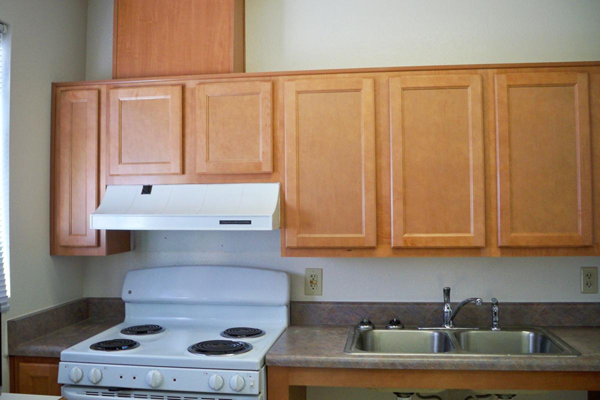 a kitchen with a stove a sink and a microwave