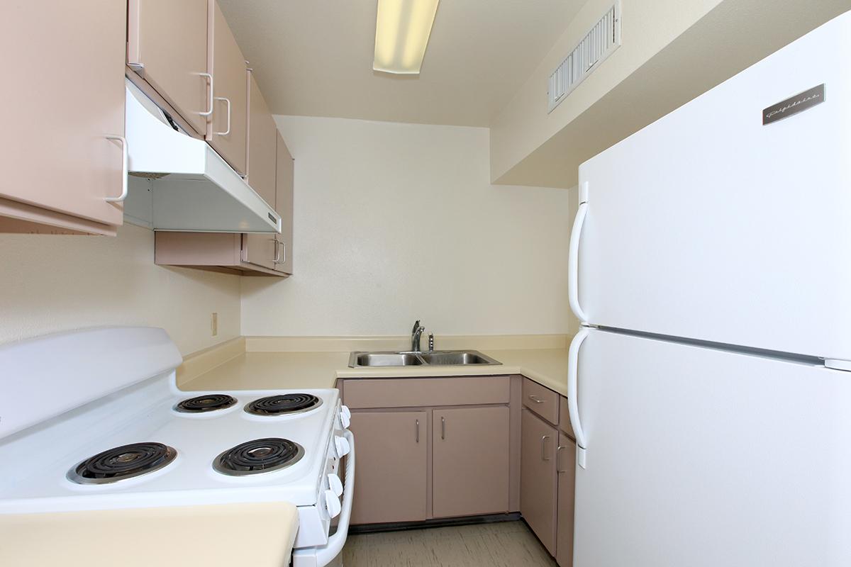 a kitchen with a white stove top oven sitting inside of a refrigerator