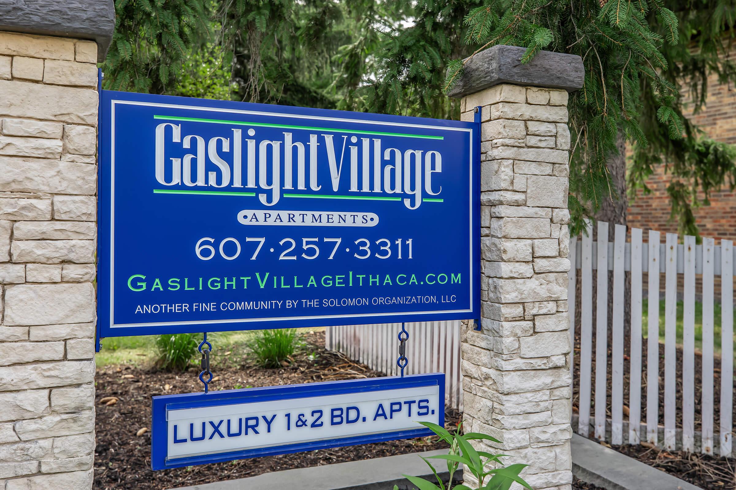 a sign in front of a brick building