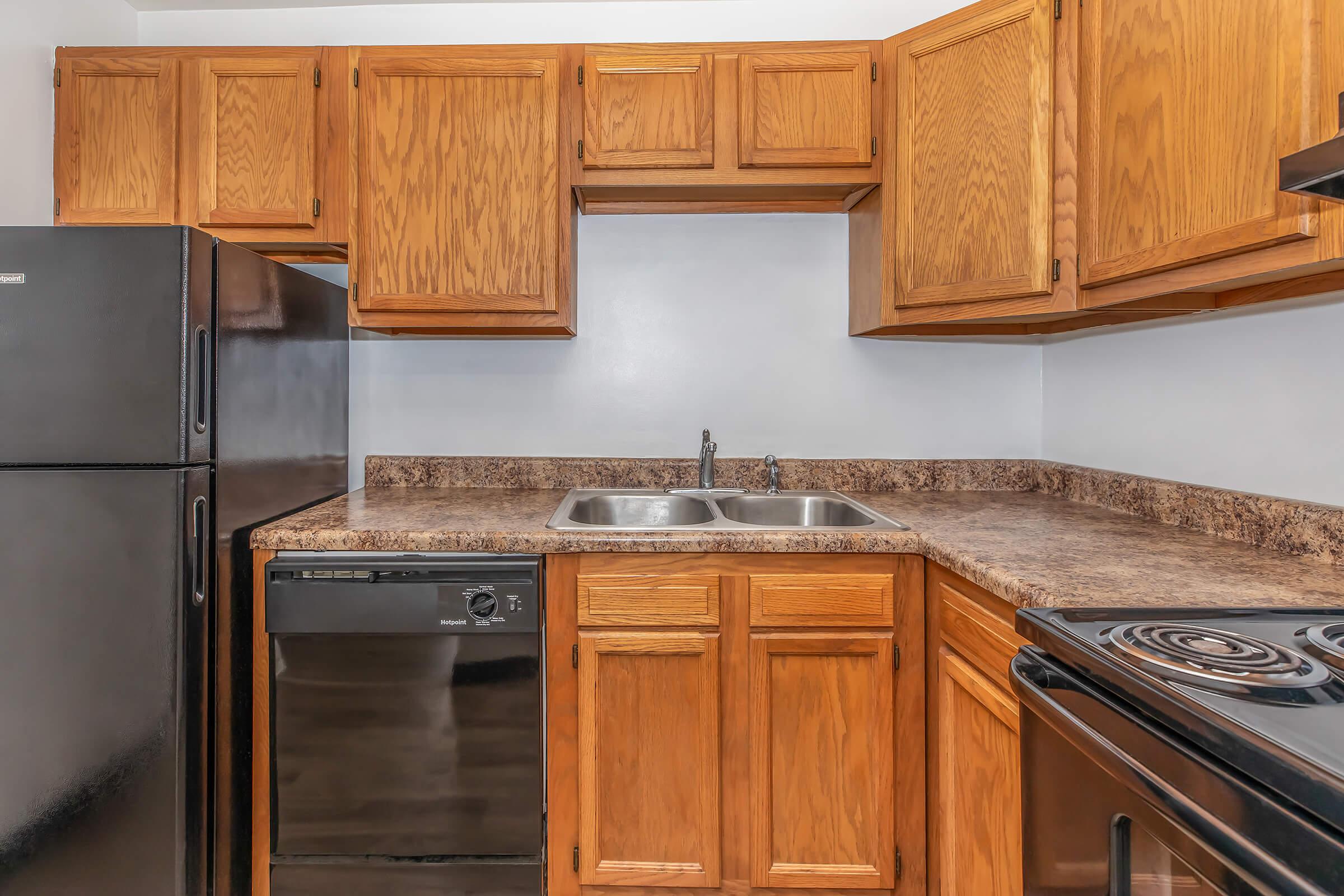 a kitchen with stainless steel appliances and wooden cabinets