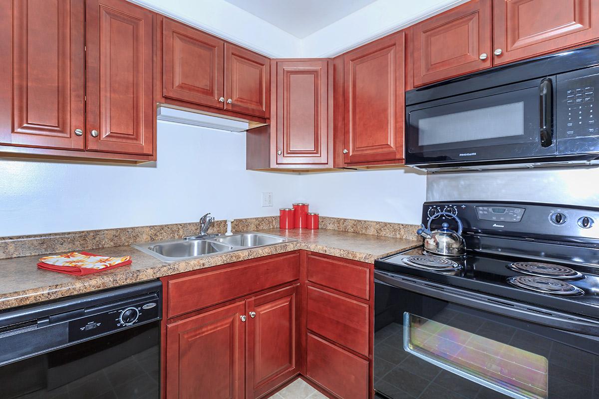 a kitchen with stainless steel appliances and wooden cabinets