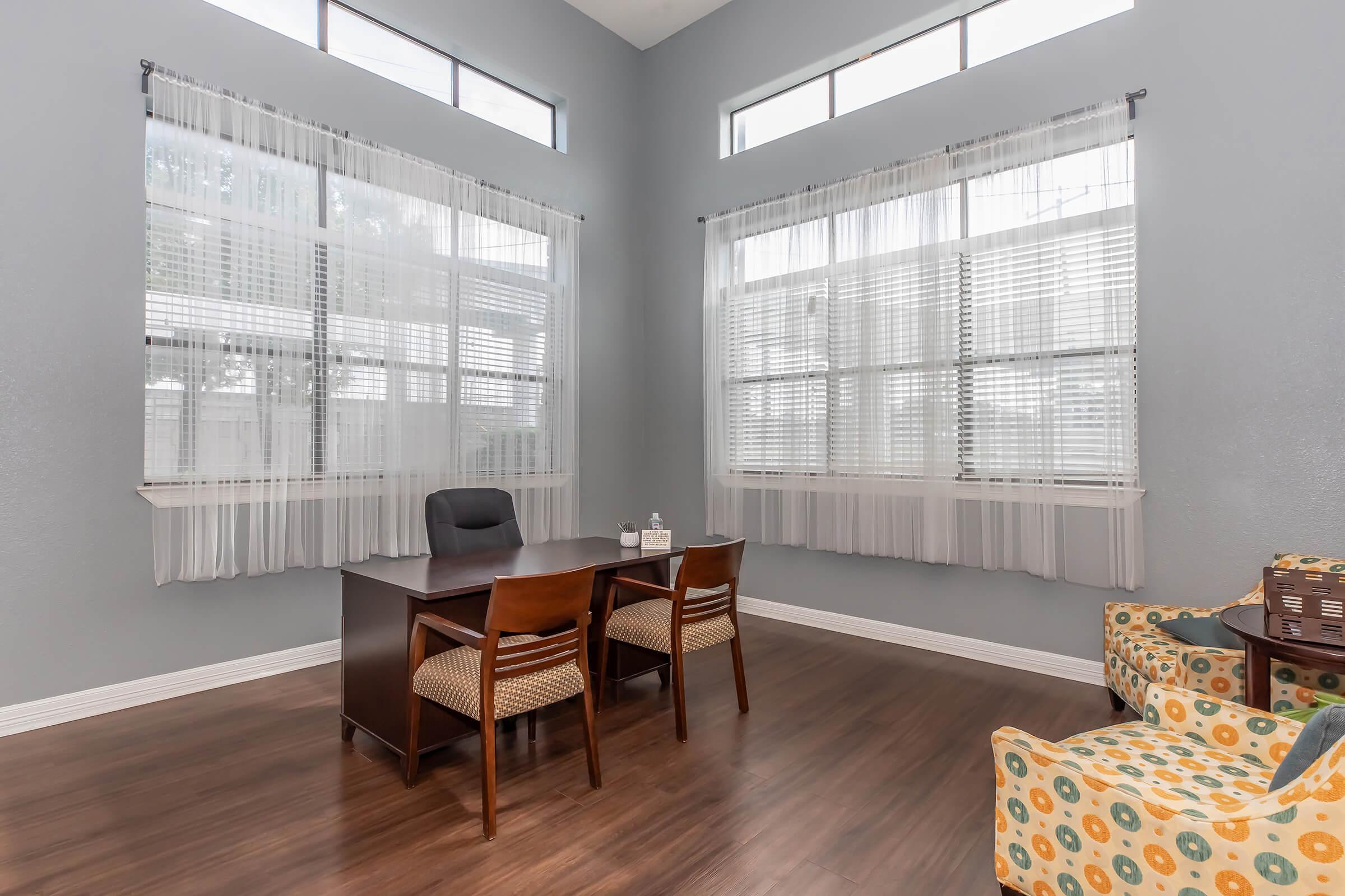 a living room filled with furniture and a large window