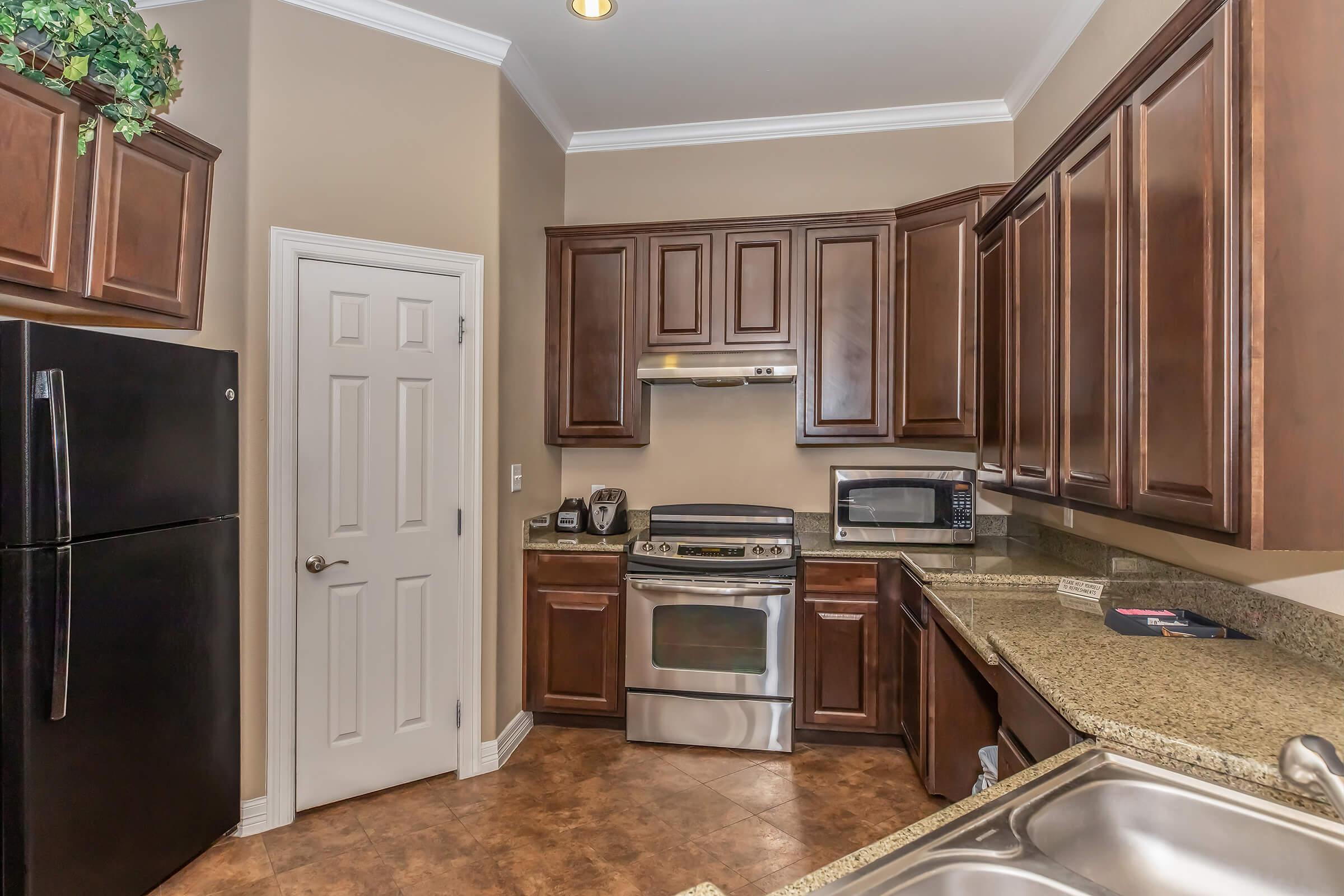 a kitchen with stainless steel appliances and wooden cabinets