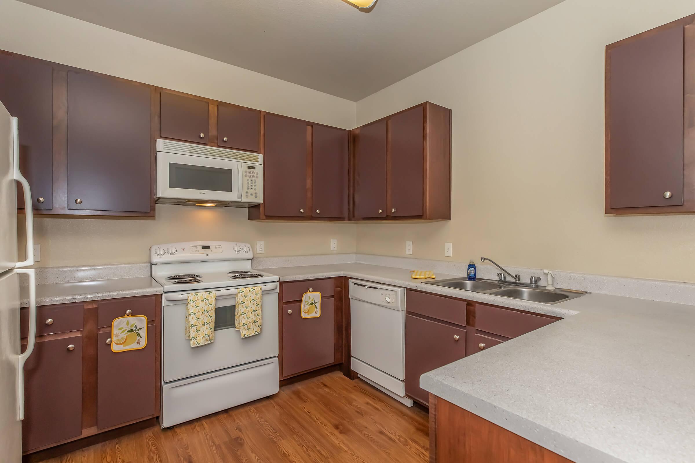 a modern kitchen with stainless steel appliances and wooden cabinets