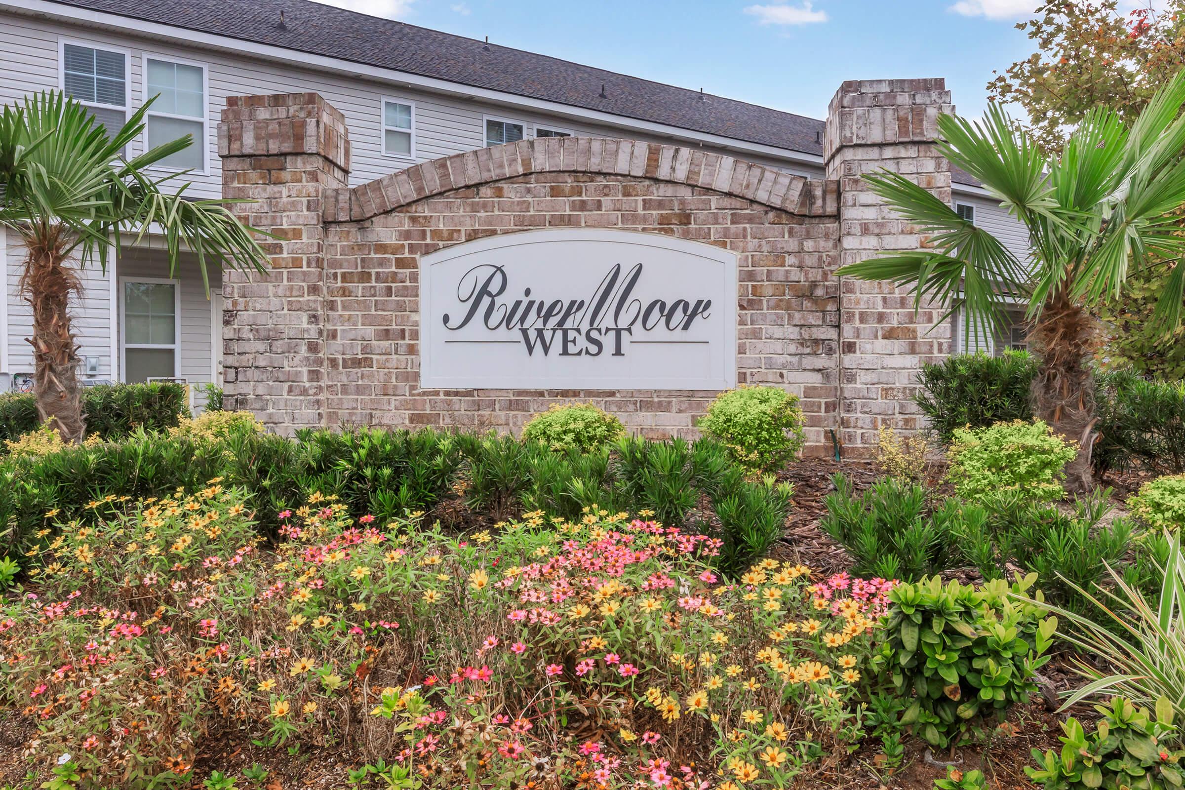 a close up of a flower garden in front of a building