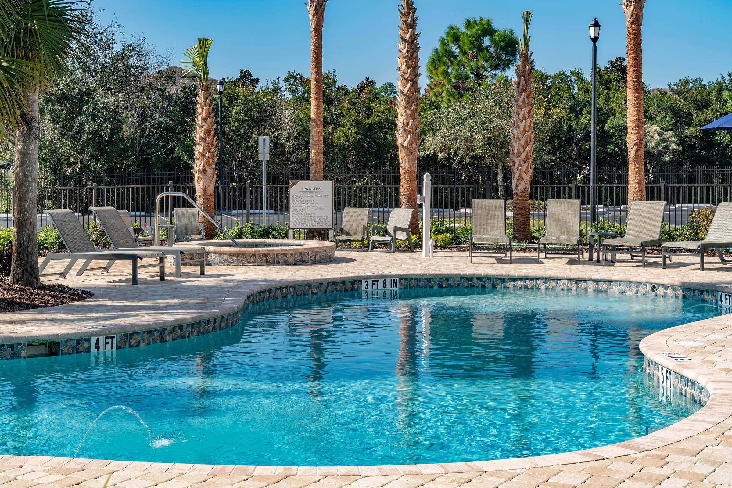 a group of lawn chairs sitting on top of a swimming pool