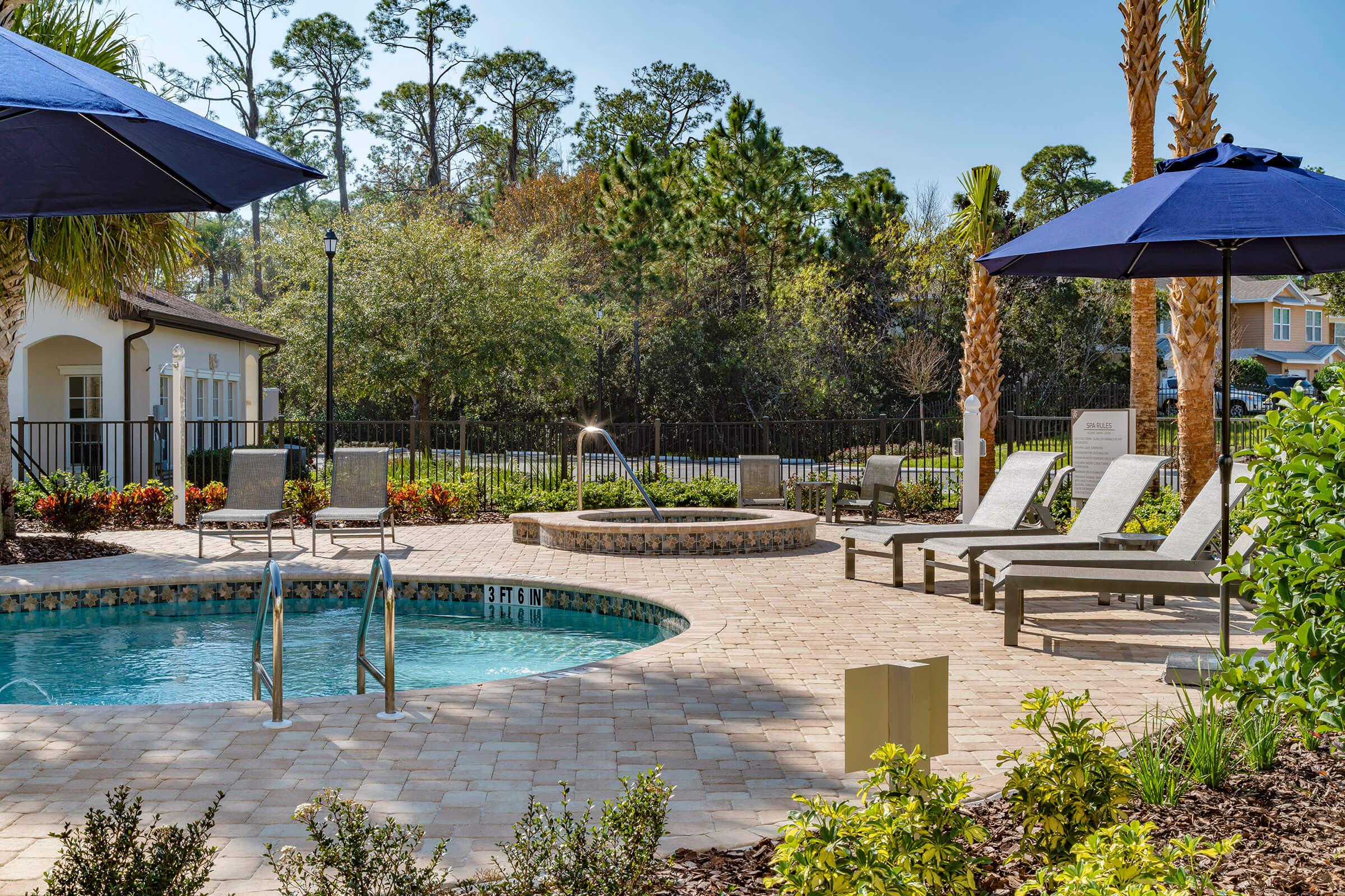 a house that has a umbrella in a pool of water