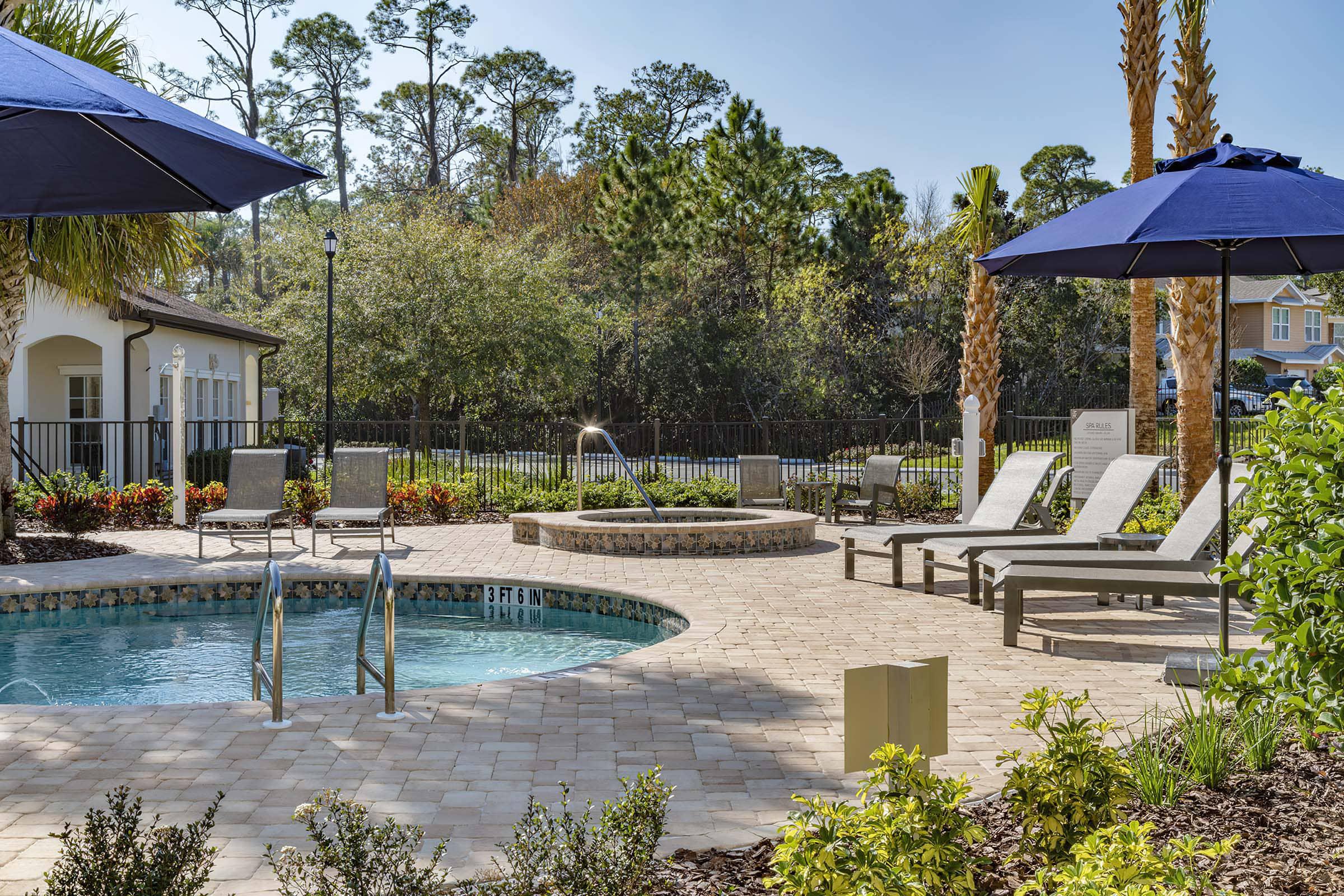 a house that has a umbrella in a pool