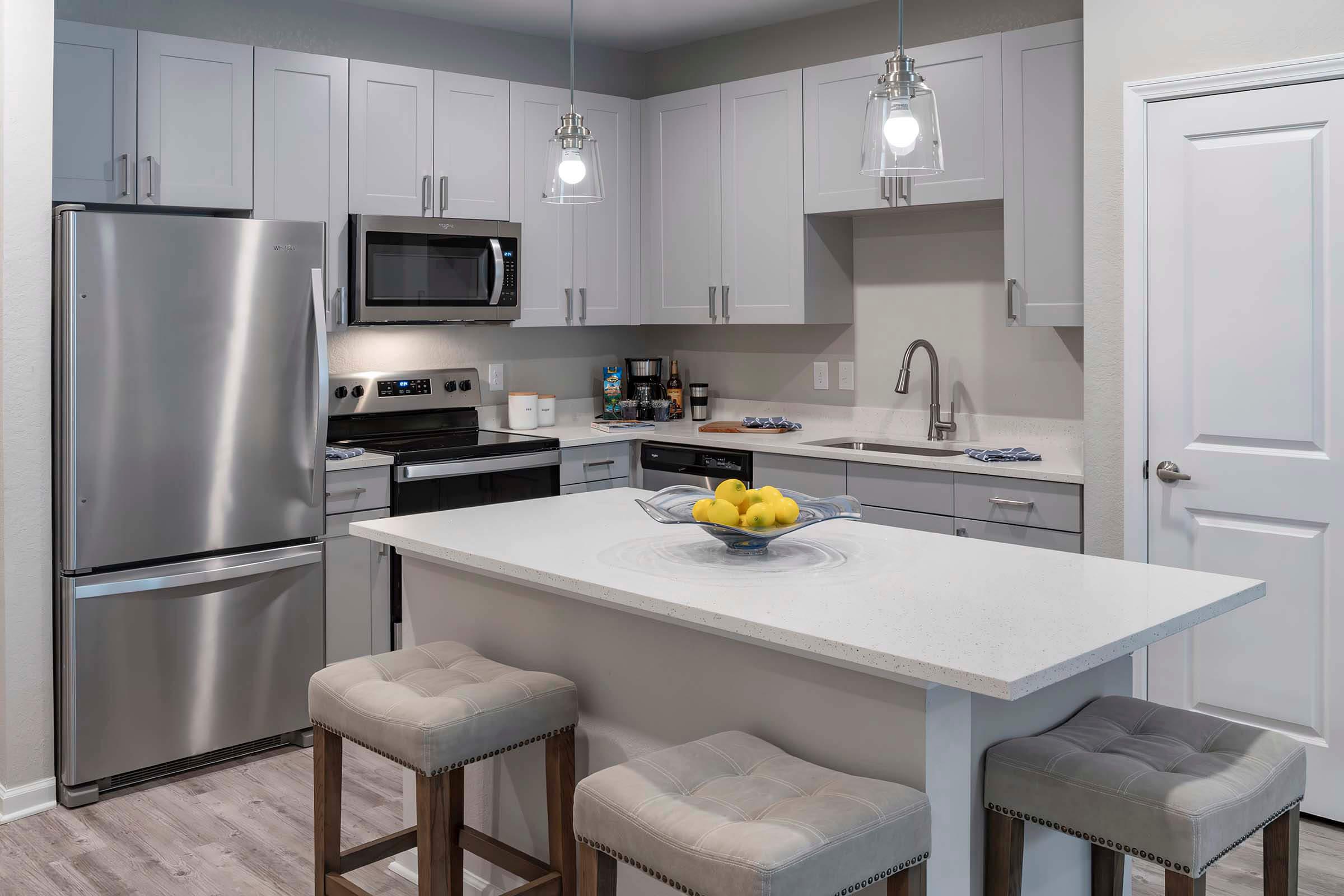 a kitchen with a sink and a refrigerator