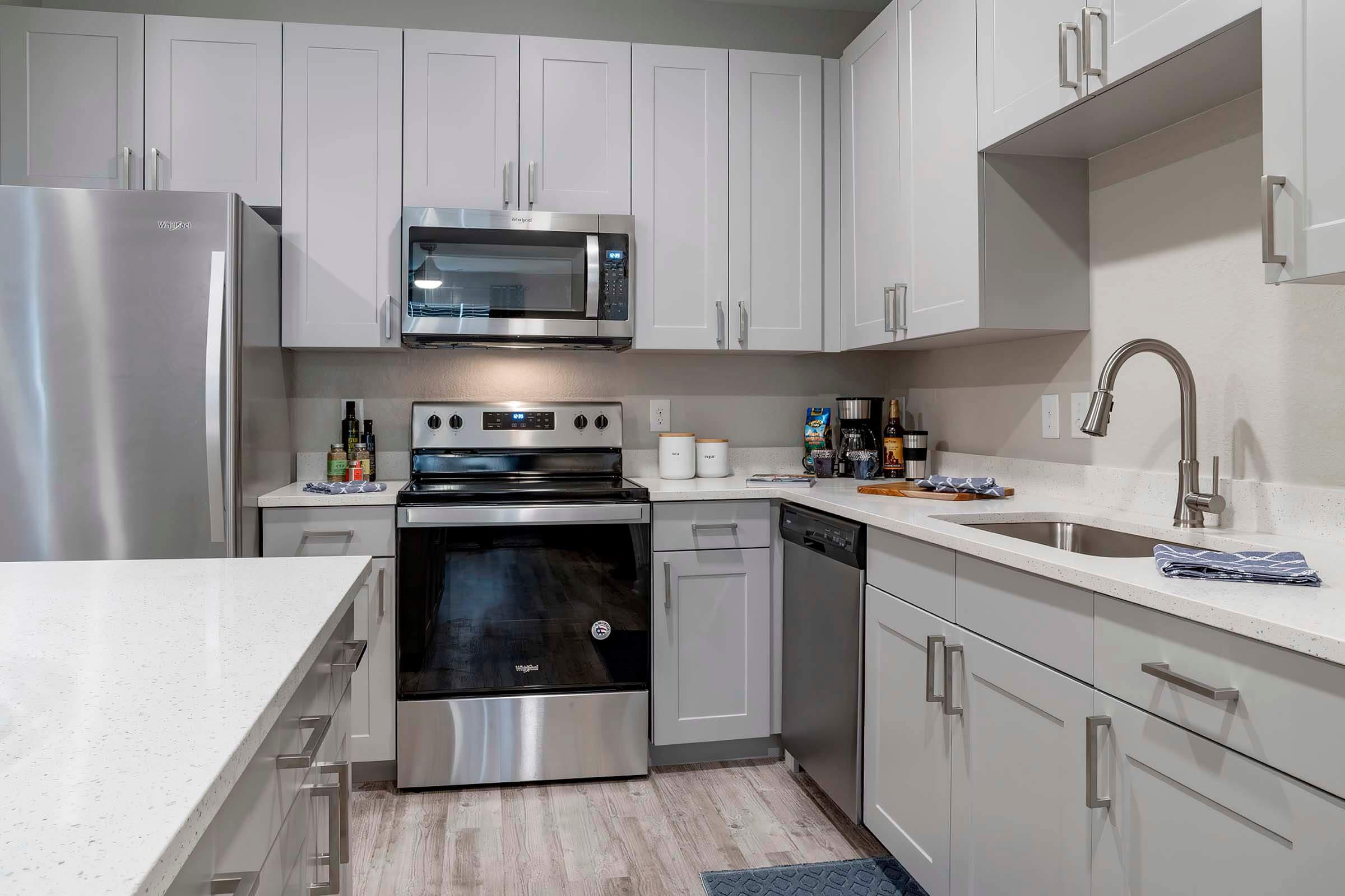 a kitchen with a sink and a microwave