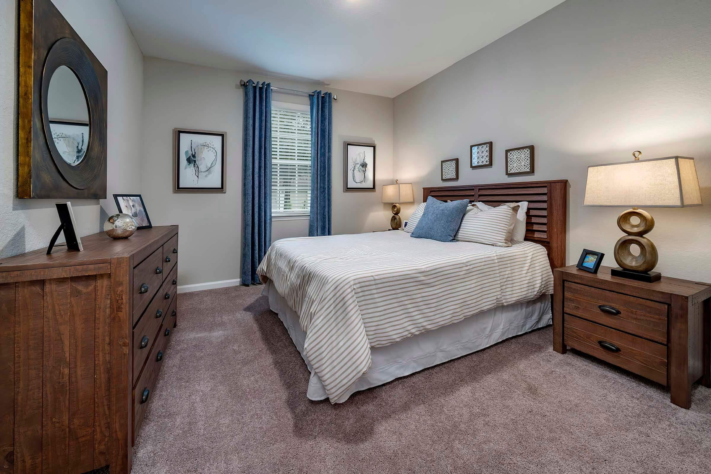 a bedroom with a bed and desk in a room