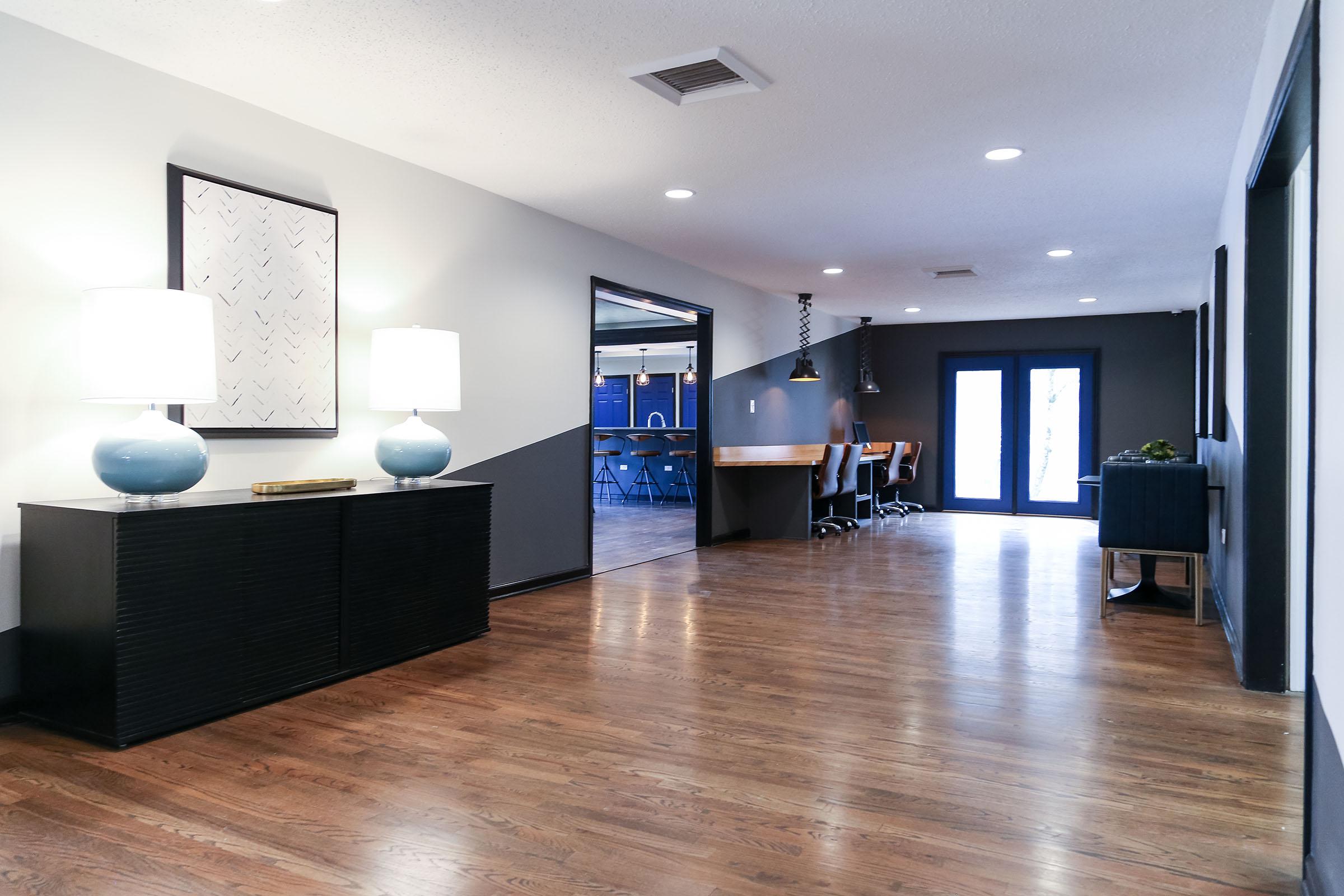 a living room filled with furniture on top of a hard wood floor