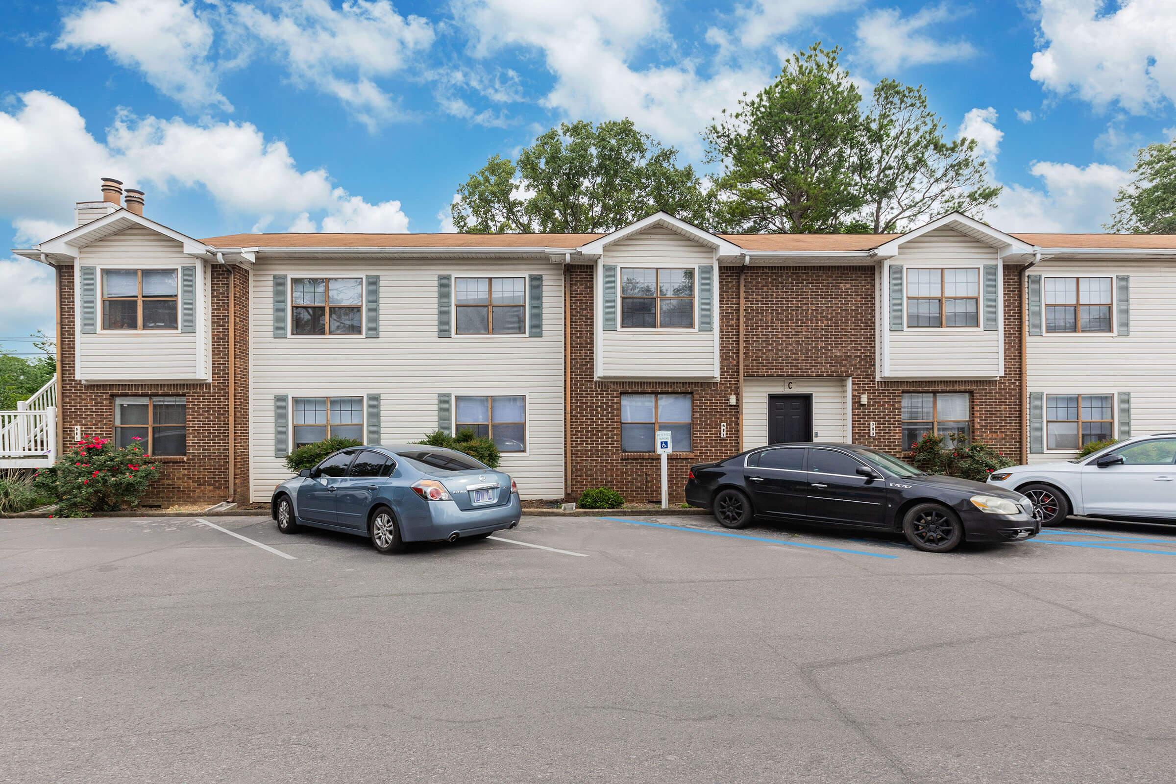 a car parked in a parking lot in front of a house