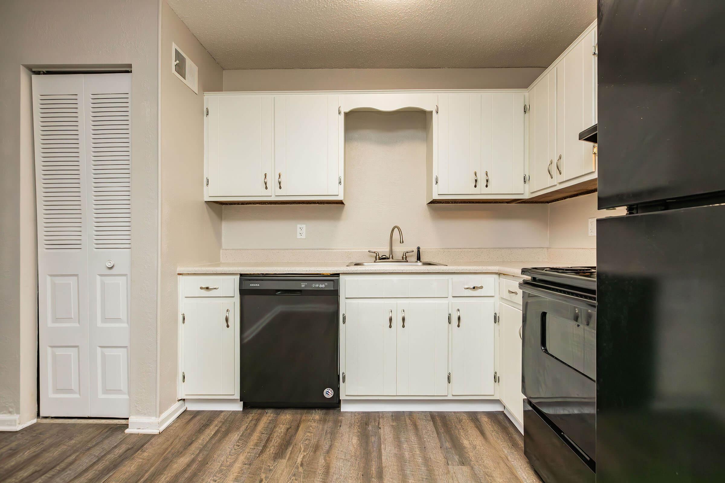 a kitchen with a stove and a refrigerator