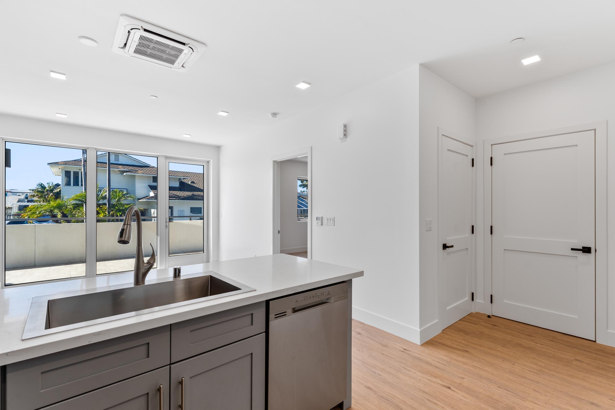 a kitchen with a sink and a mirror