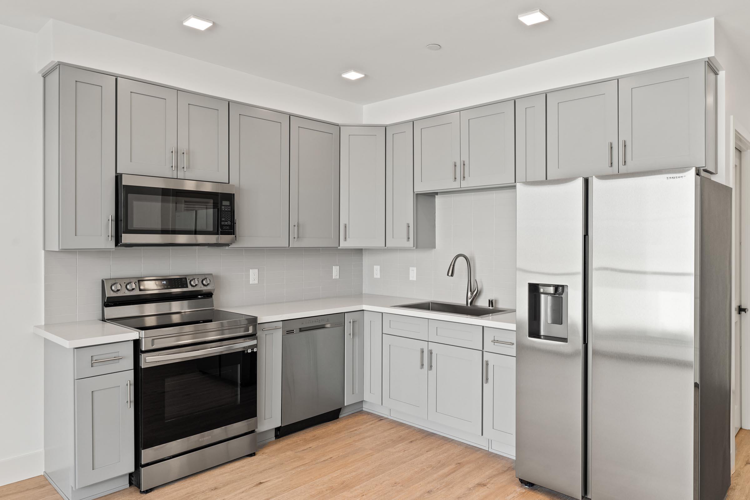 a kitchen with a refrigerator and a microwave