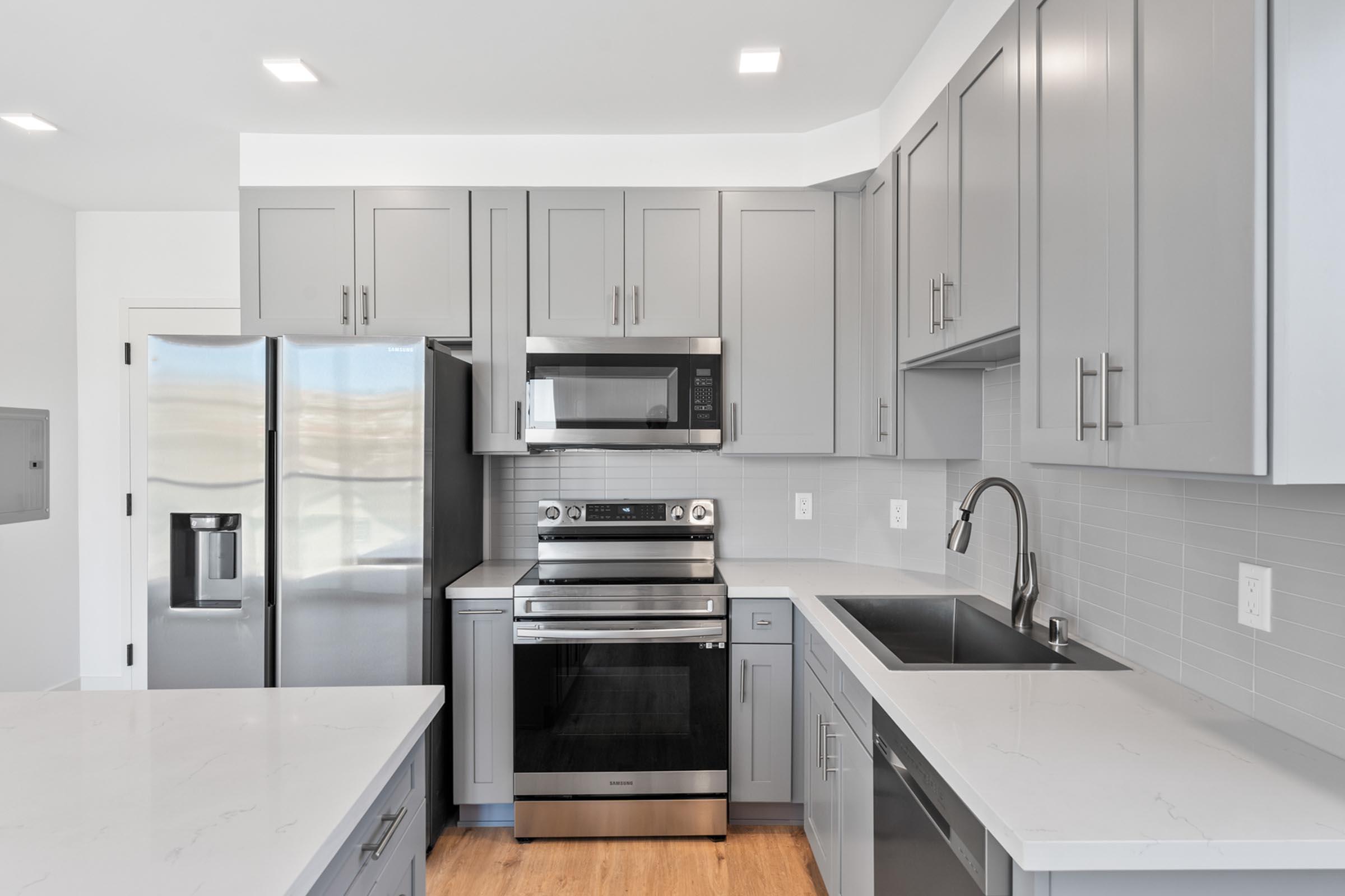 a kitchen with a stove a sink and a microwave