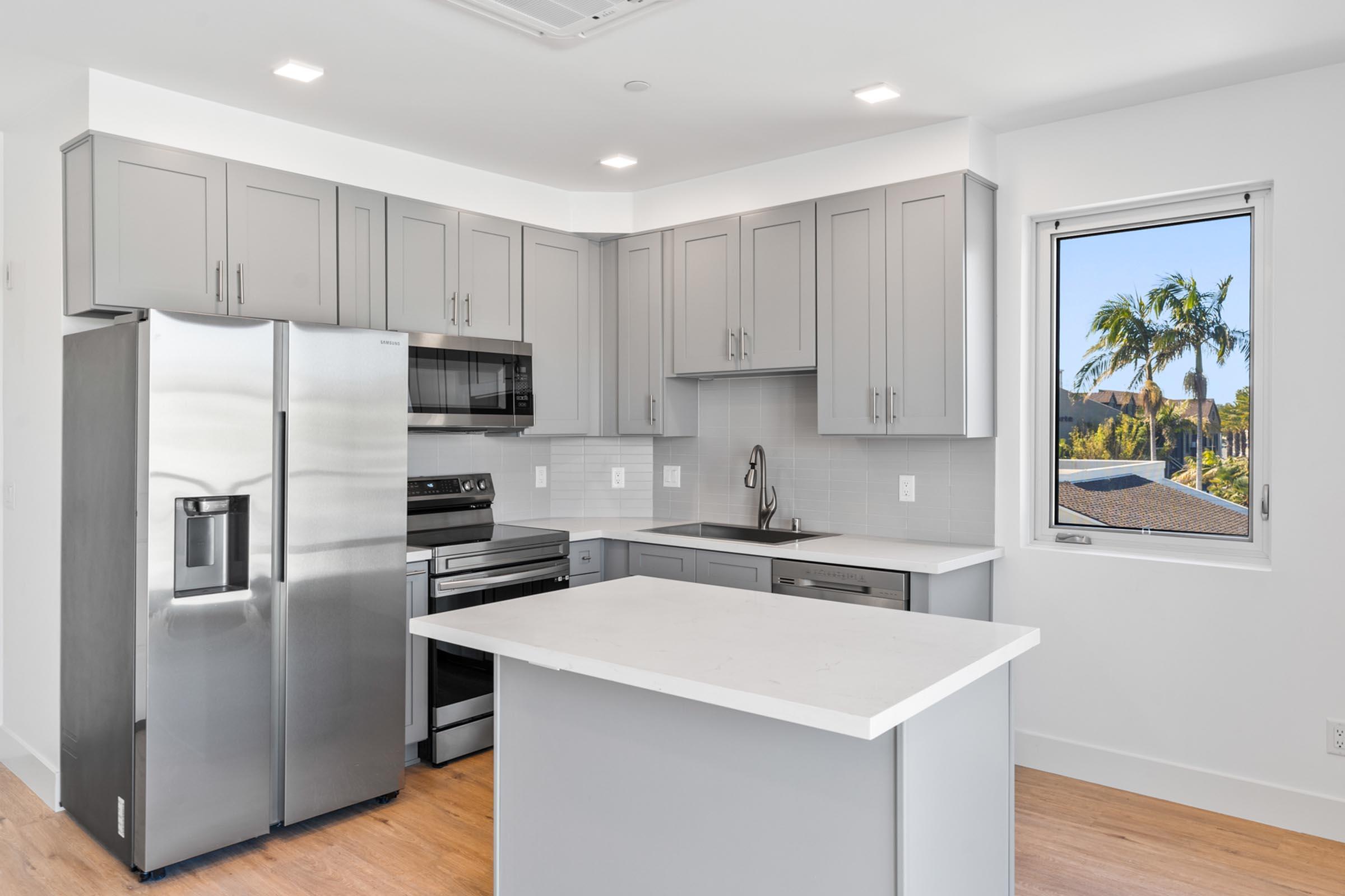 a kitchen with a sink and a refrigerator