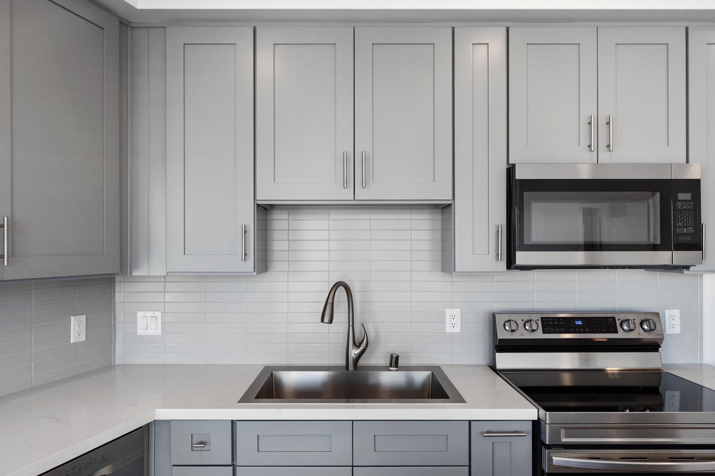 a kitchen with a stove a sink and a microwave