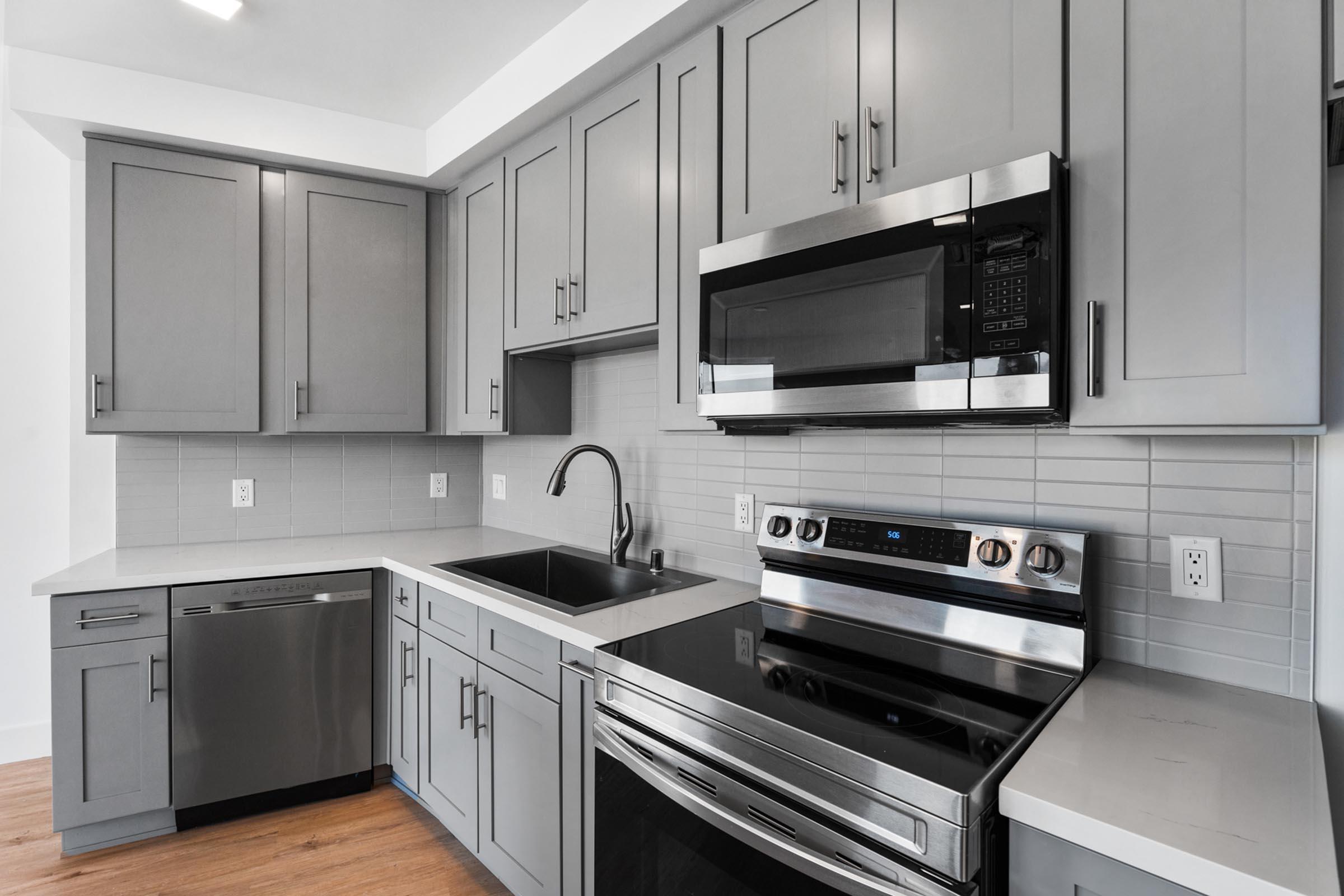 a stove top oven sitting inside of a kitchen