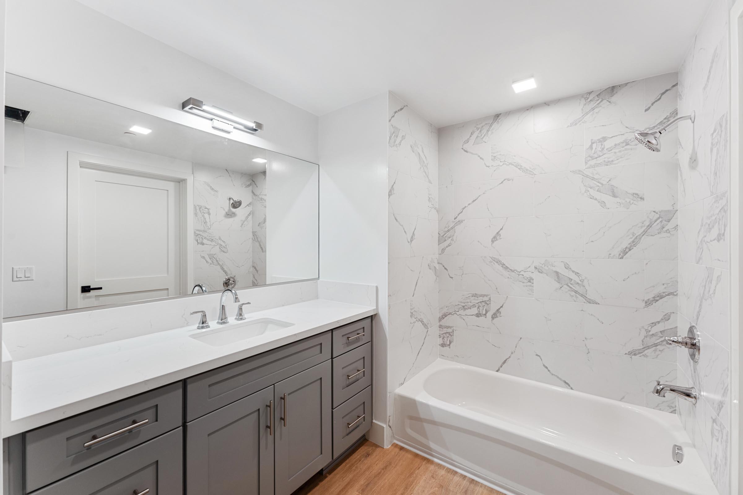 a kitchen with a sink and a mirror