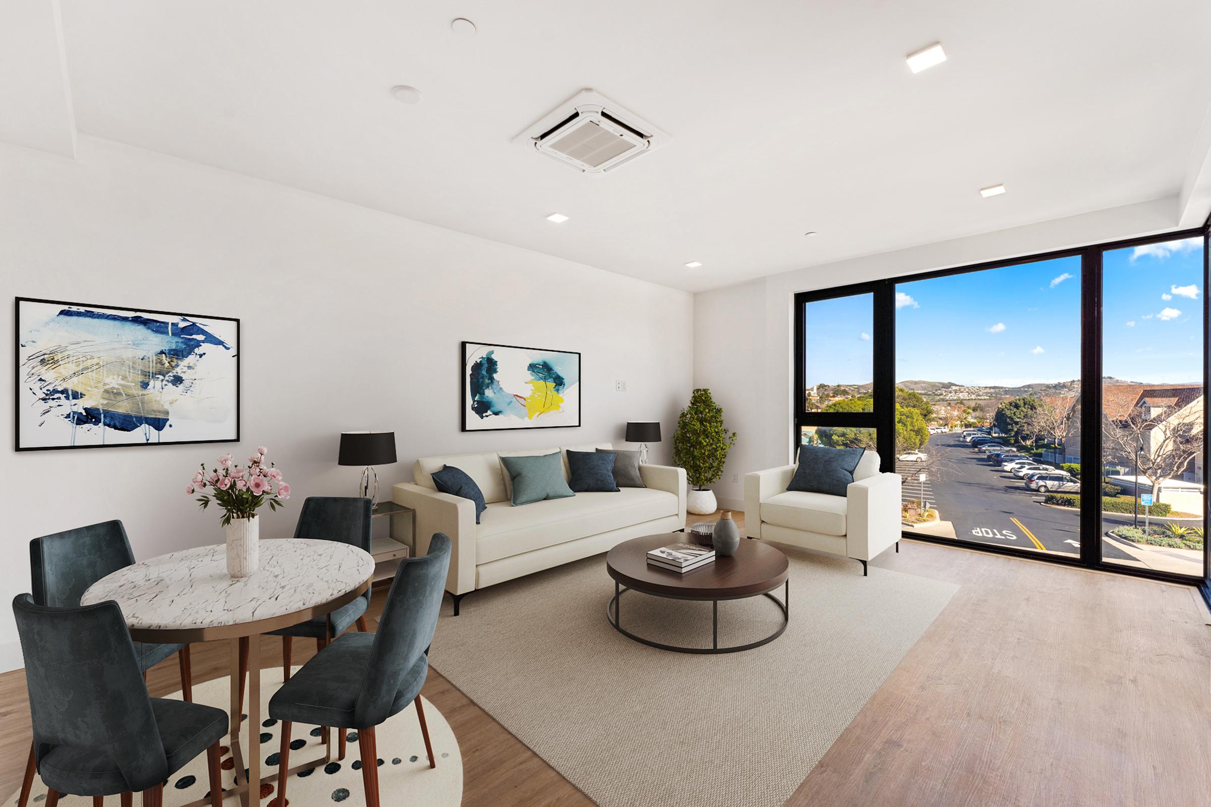 a living room filled with furniture and a large window