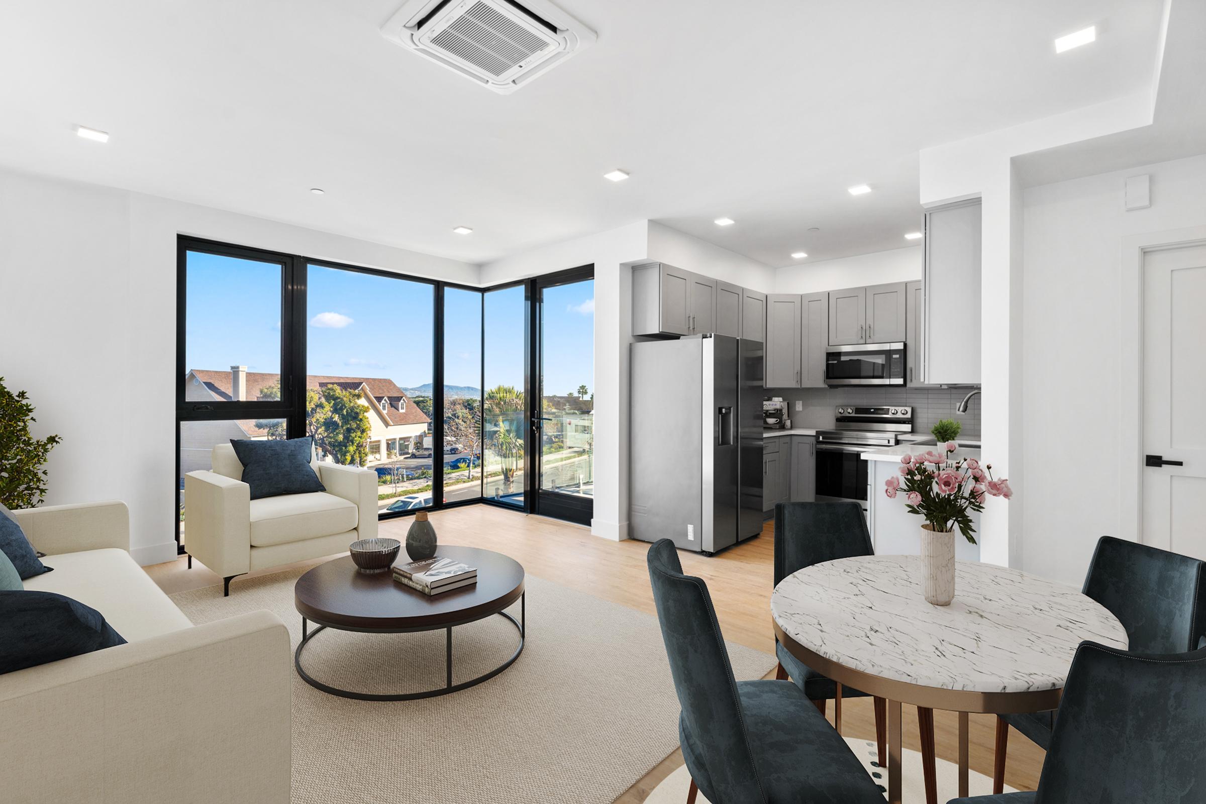 a living room filled with furniture and a large window