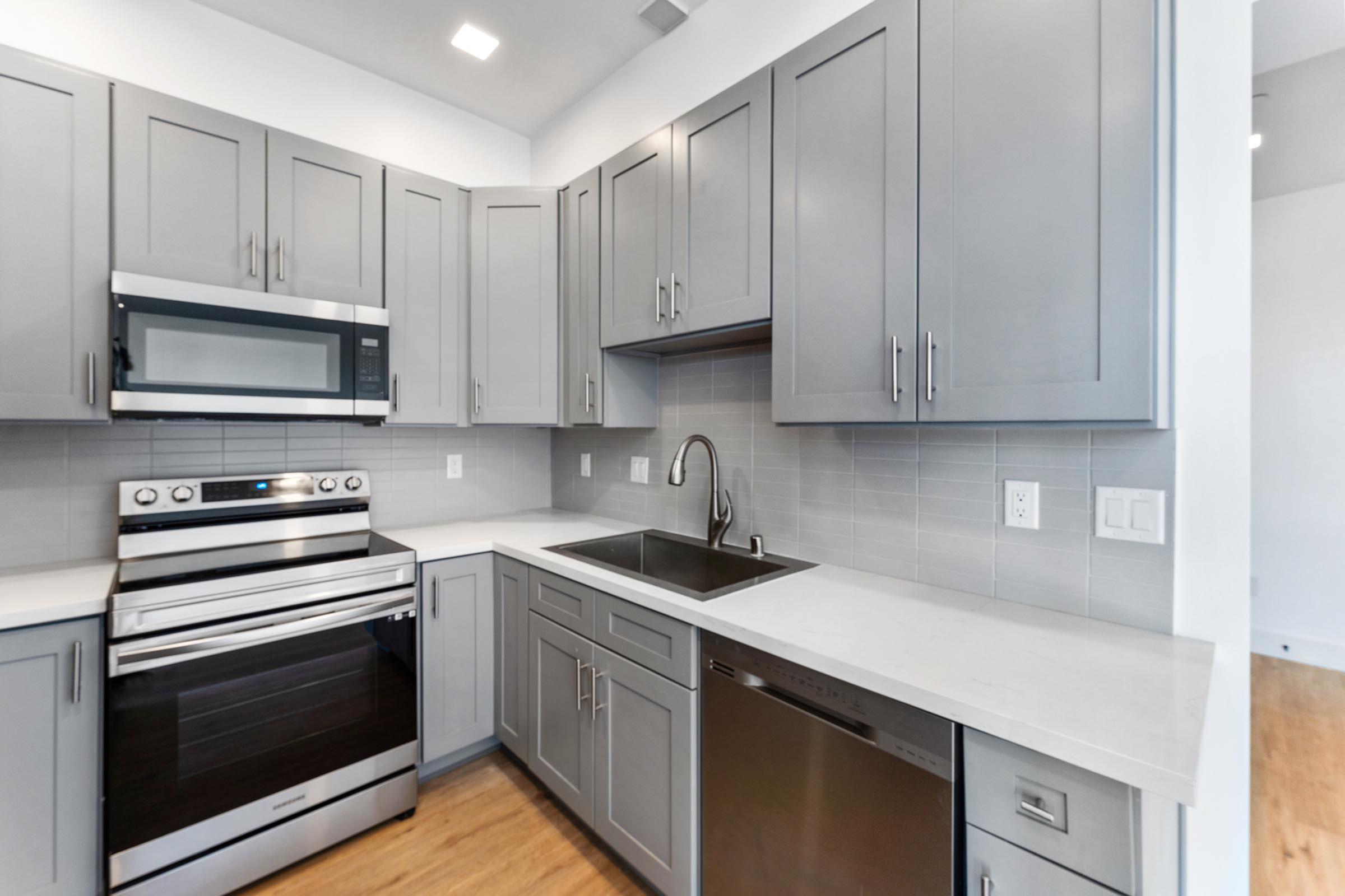 a kitchen with a stove a sink and a microwave