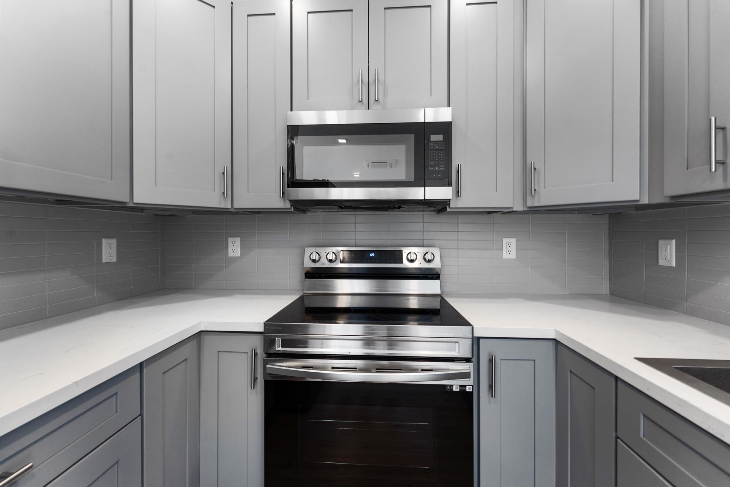 a kitchen with stainless steel appliances and wooden cabinets