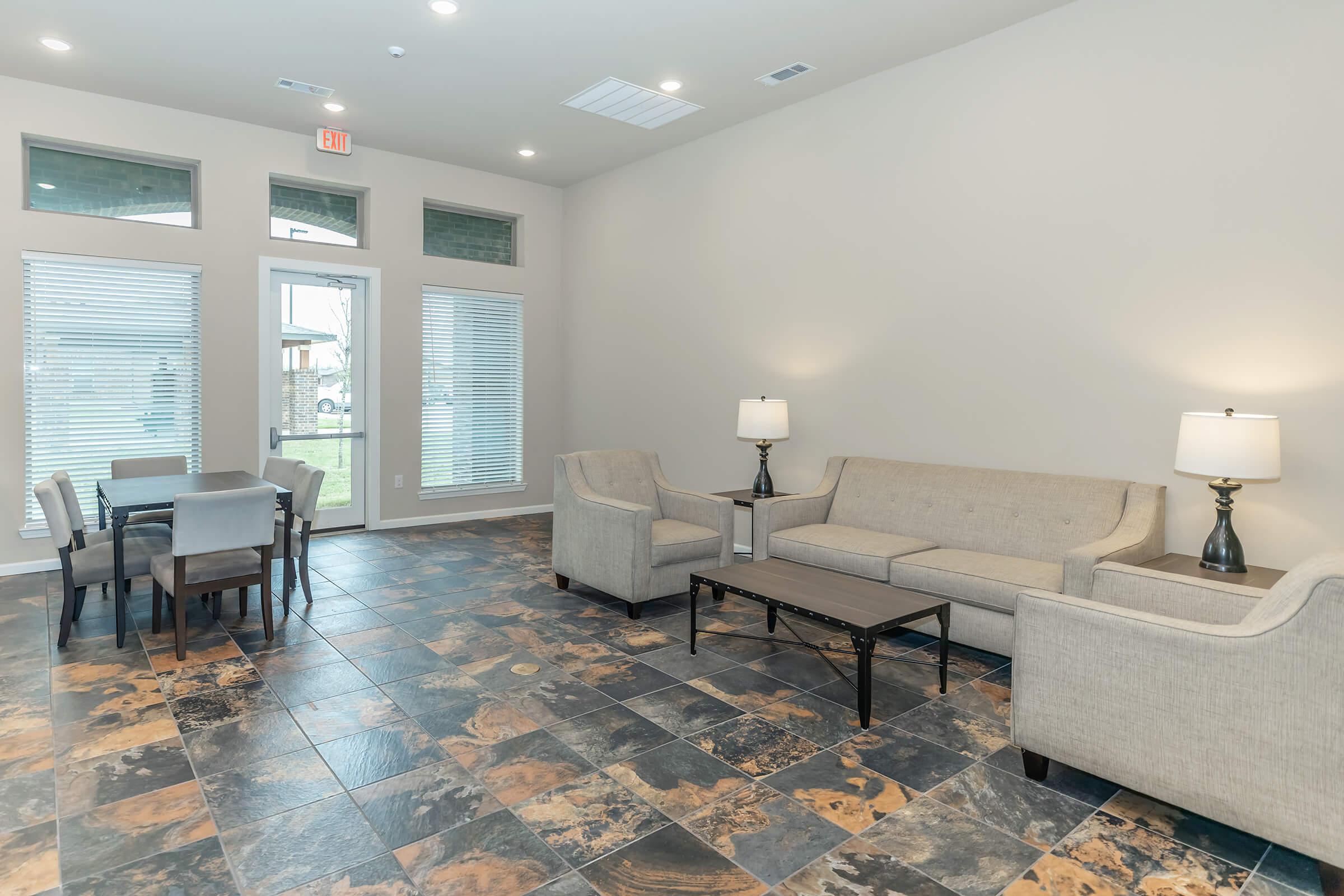 a living room filled with furniture and a large window