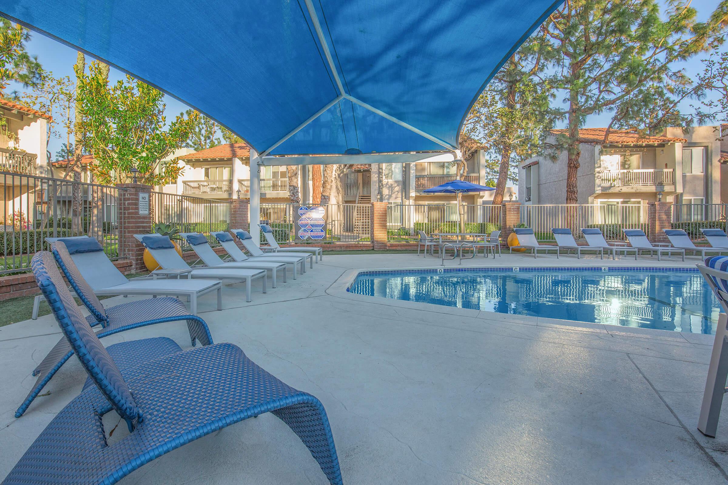 a person sitting at a table with a blue umbrella