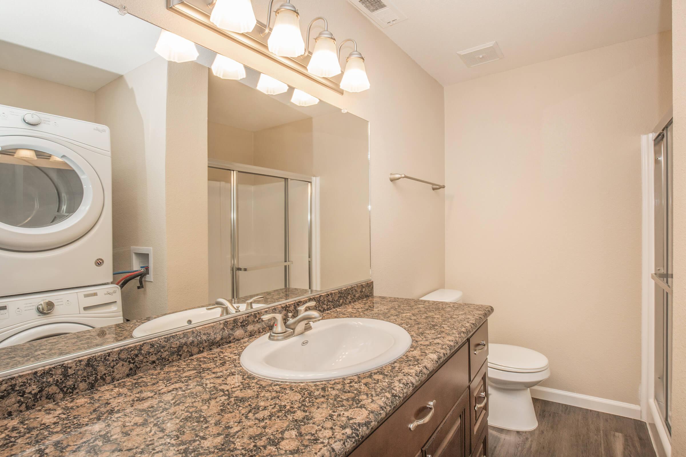 a restroom with a sink and a mirror