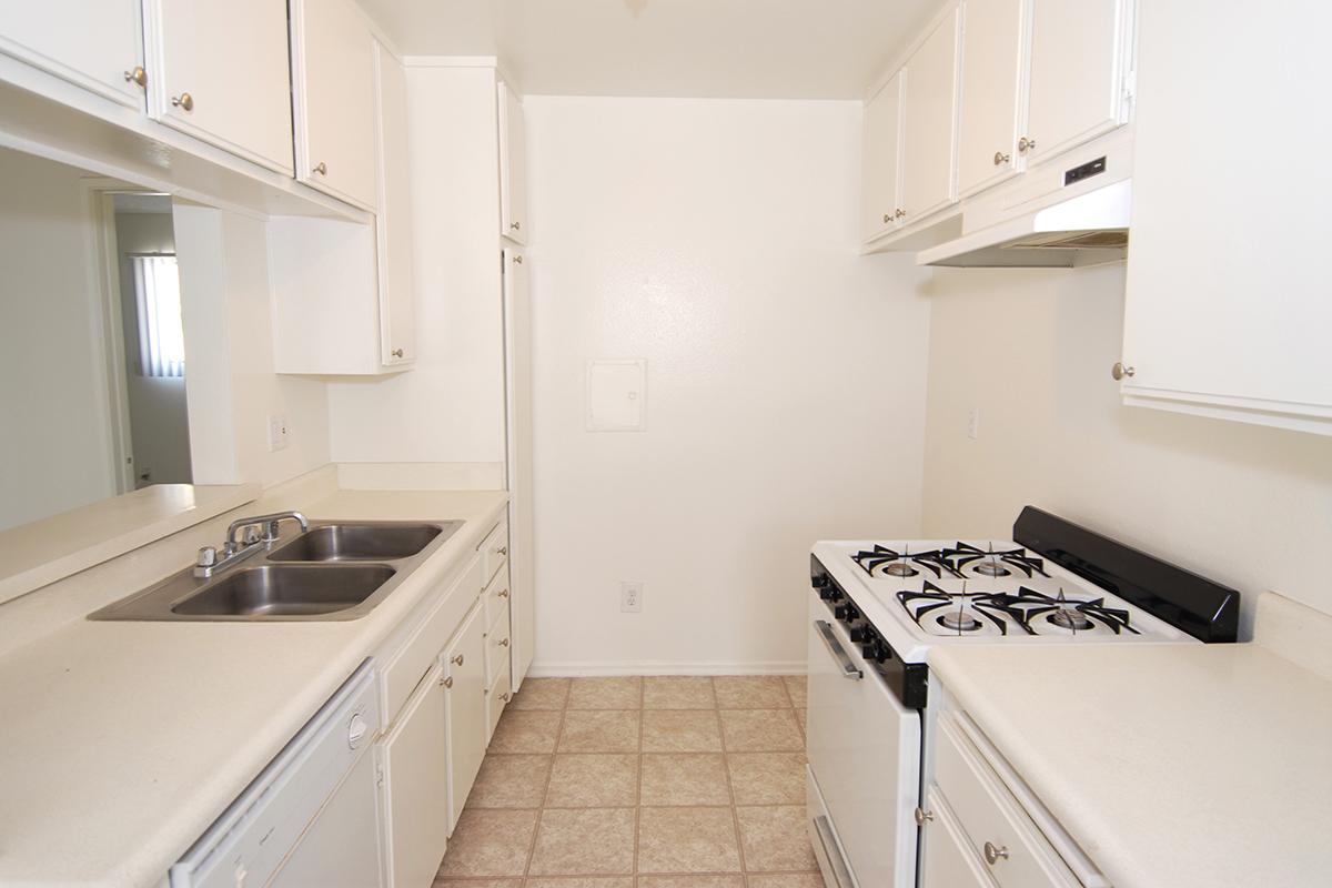 a white stove top oven sitting inside of a kitchen