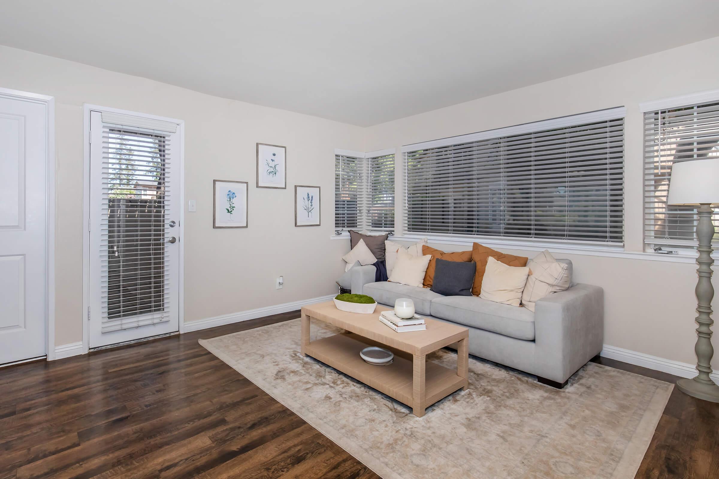 a living room filled with furniture and a large window