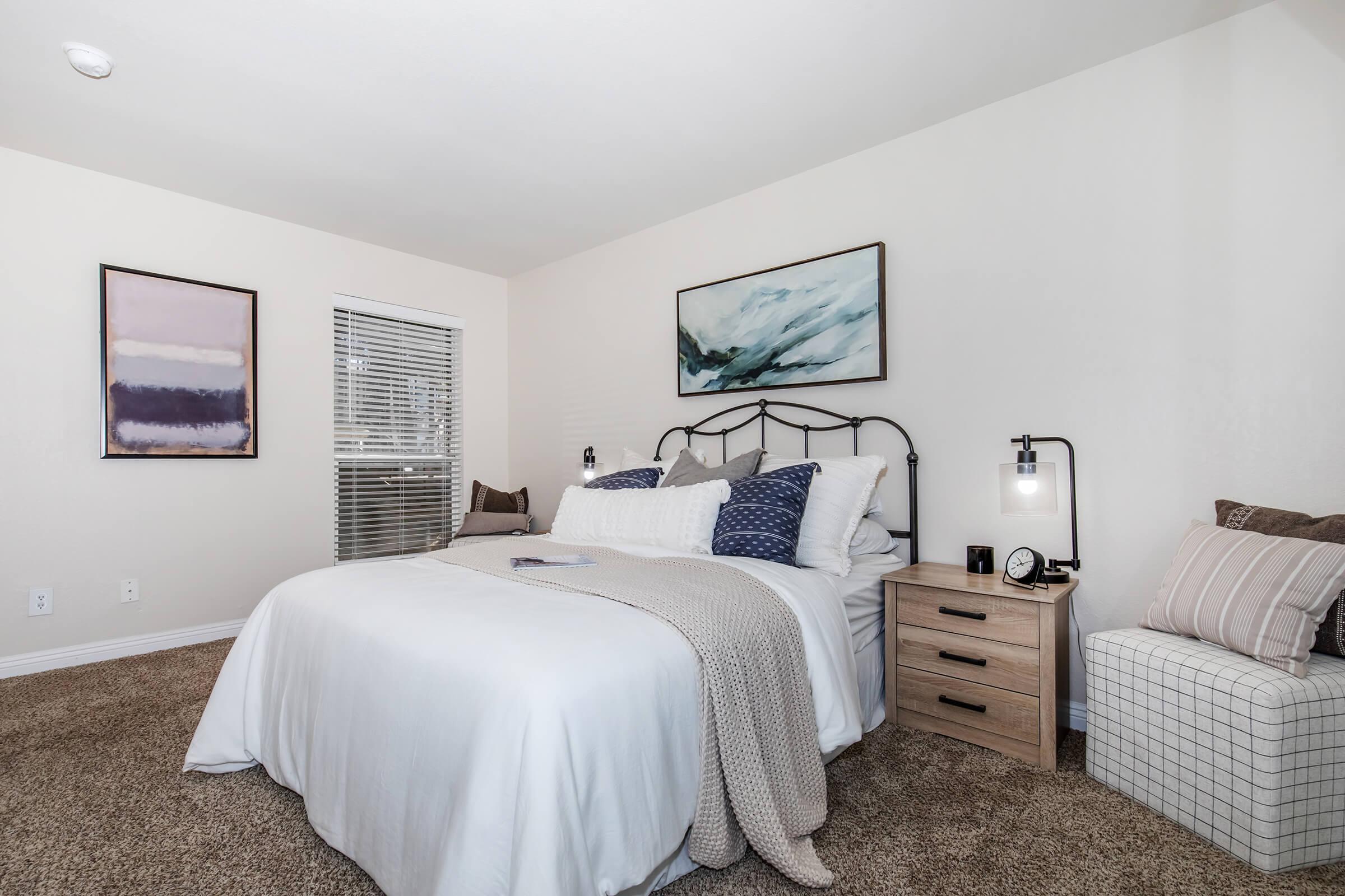 a bedroom with a bed and desk in a room