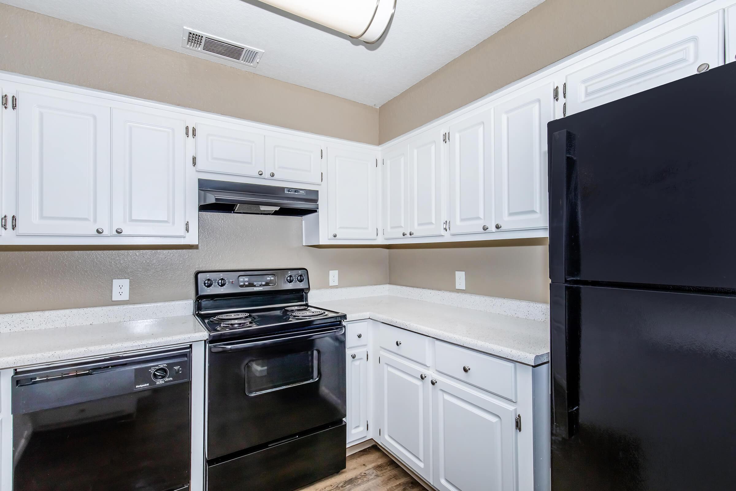 a stove top oven sitting inside of a kitchen