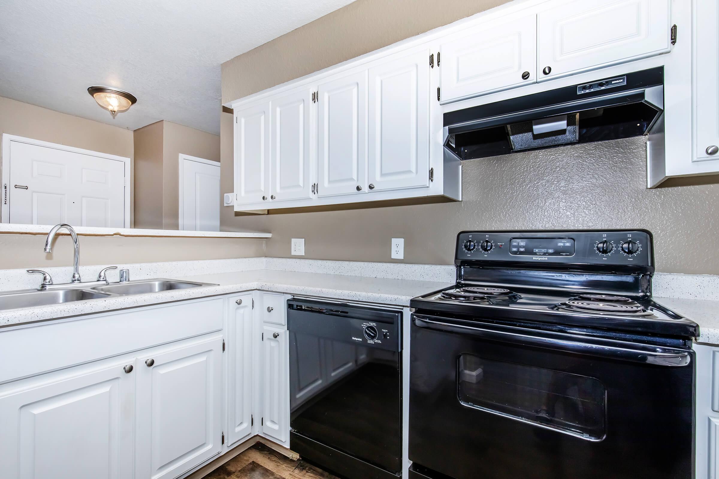 a stove top oven sitting inside of a kitchen