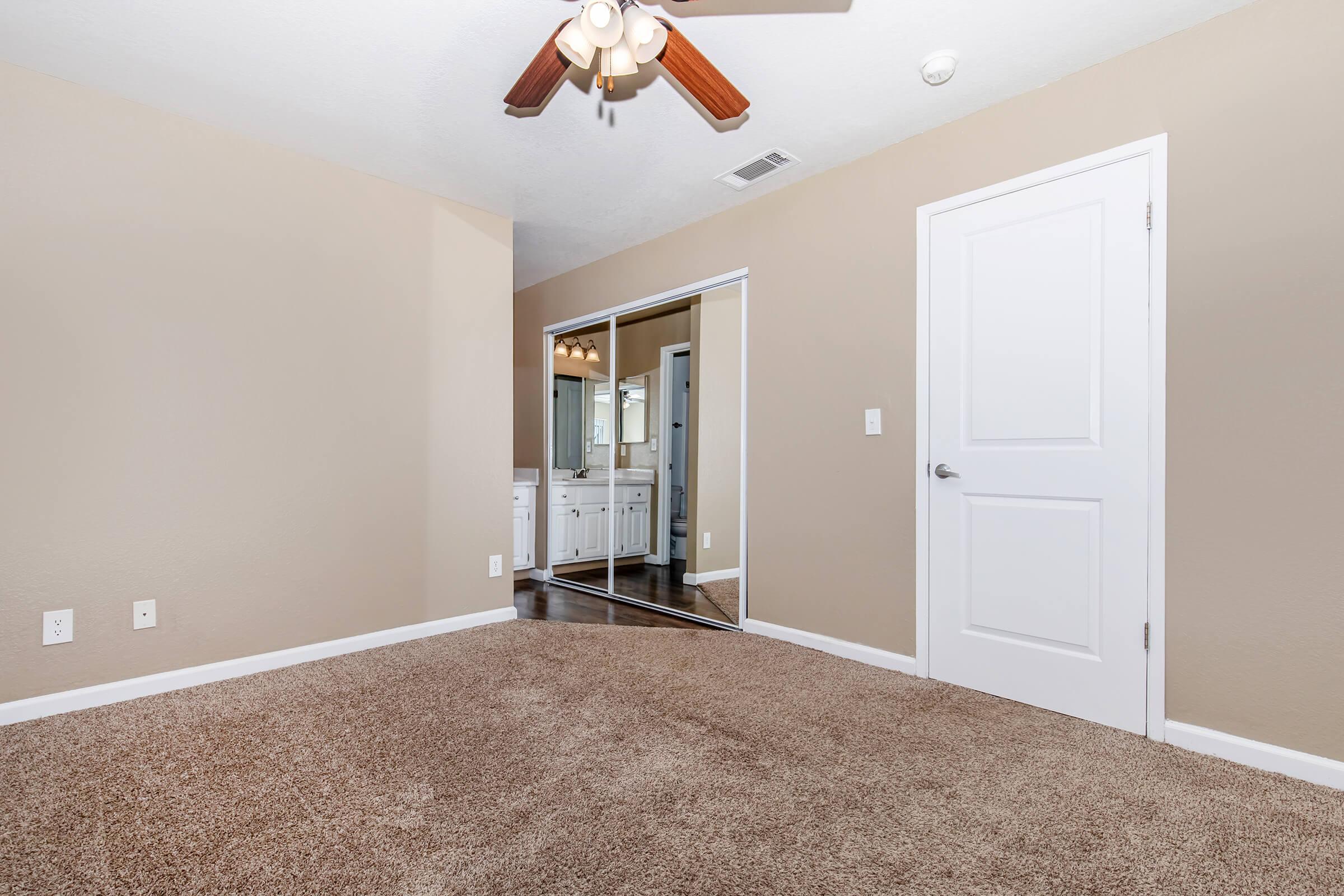 a bedroom with a large mirror