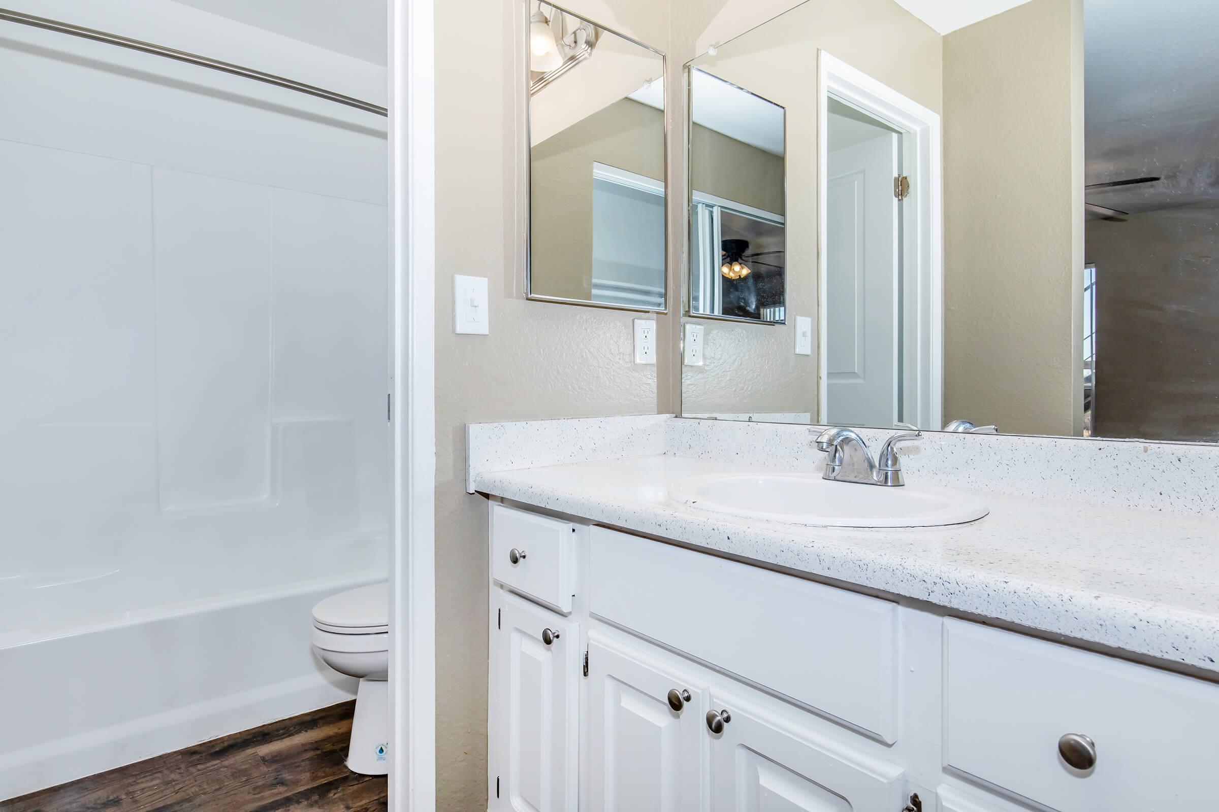 a kitchen with a sink and a mirror