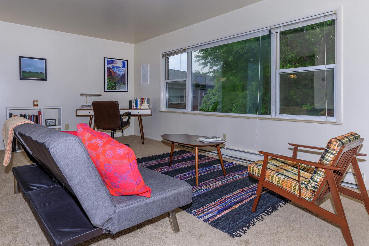 a large red chair in the living room