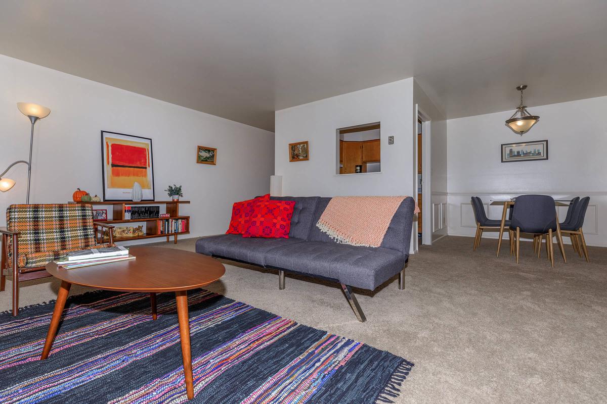 a living room filled with furniture and a flat screen tv