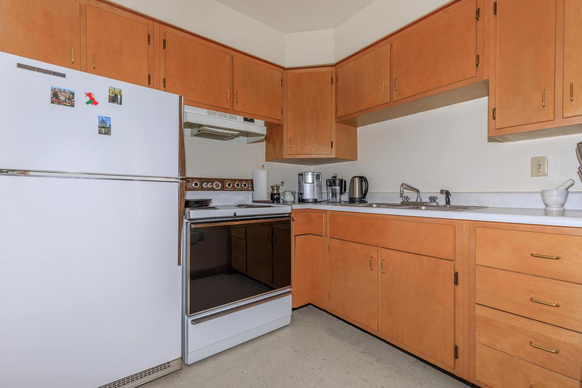 a white refrigerator freezer sitting inside of a kitchen