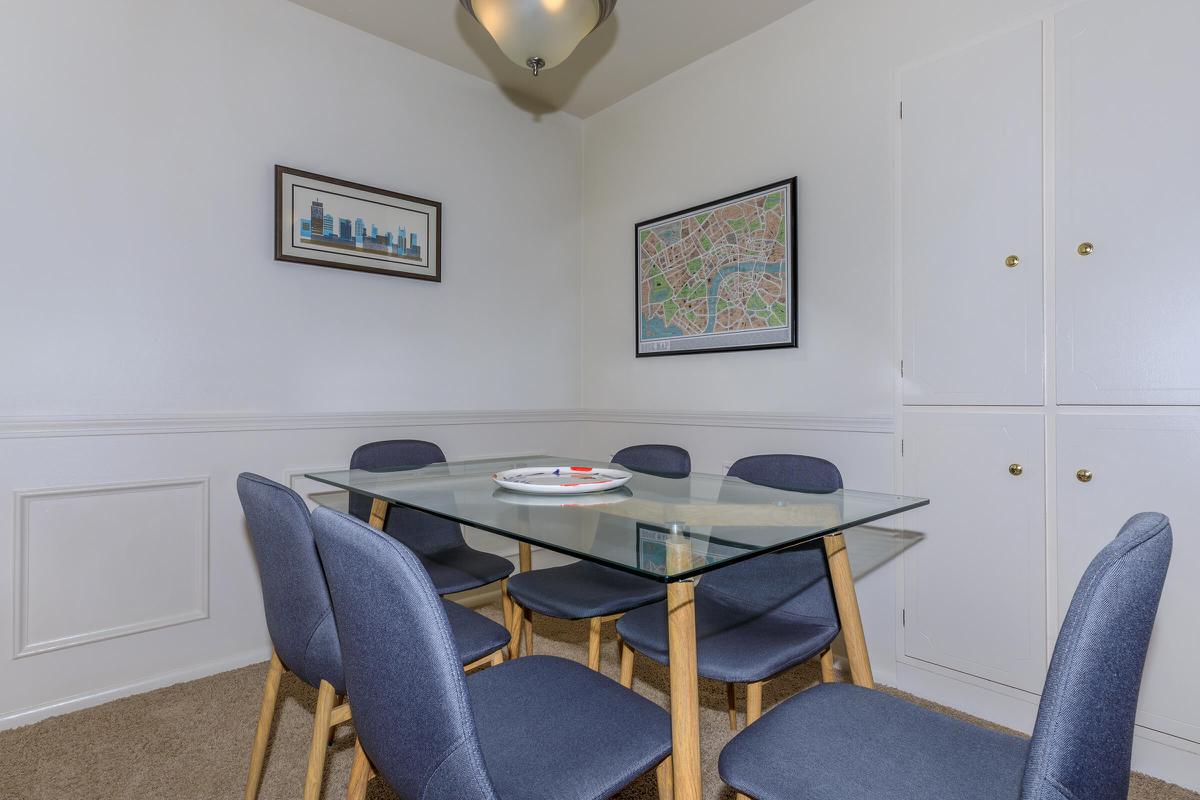 a desk with a computer and a chair in a room